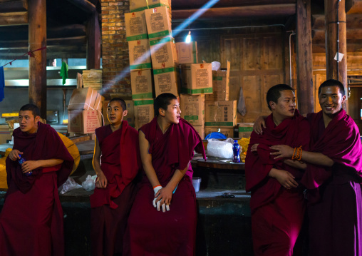 Monks in the kitchen of Rongwo monastery, Tongren County, Longwu, China