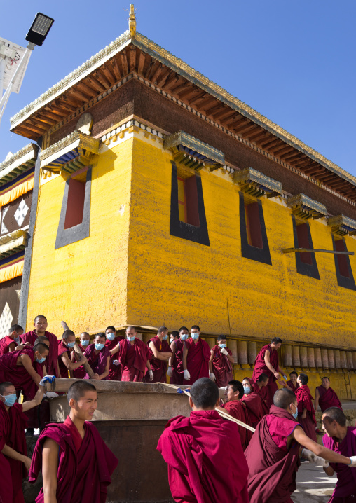 Monks preparing the painting of a temple in Rongwo monastery, Tongren County, Longwu, China