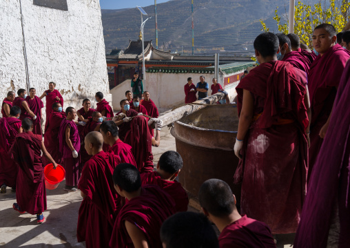 Monks preparing the painting of a temple in Rongwo monastery, Tongren County, Longwu, China