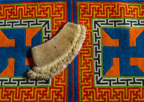 Yellow hat sect on a carpet with swastikas inside Bongya monastery, Qinghai province, Mosele, China