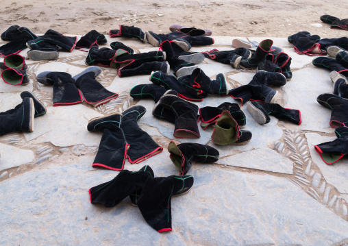 Tibetan monks boots in front of the entrance of a temple in Labrang monastery, Gansu province, Labrang, China