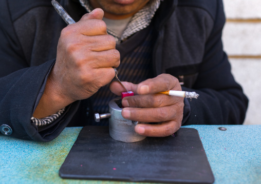 Carver making traditional chinese stamp in the street, Gansu province, Linxia, China