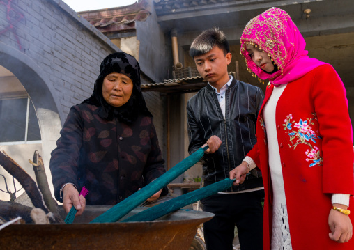 Hui muslim people burning incense stick in Yu Baba Gongbei shrine, Gansu province, Linxia, China