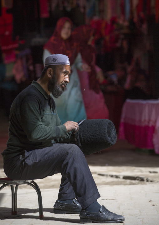 Uyghur Man Making A  sheem skin Hat, Minfeng, Xinjiang Uyghur Autonomous Region, China