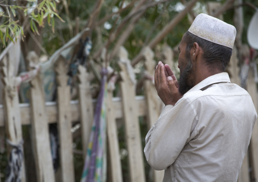 Man Praying At Imam Asim Tomb In The Taklamakan Desert, Xinjiang Uyghur Autonomous Region, China