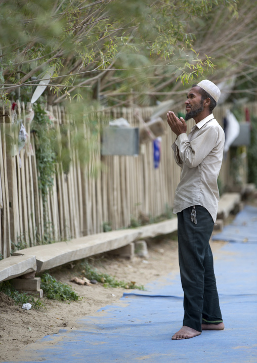 Man Praying At Imam Asim Tomb In The Taklamakan Desert, Xinjiang Uyghur Autonomous Region, China