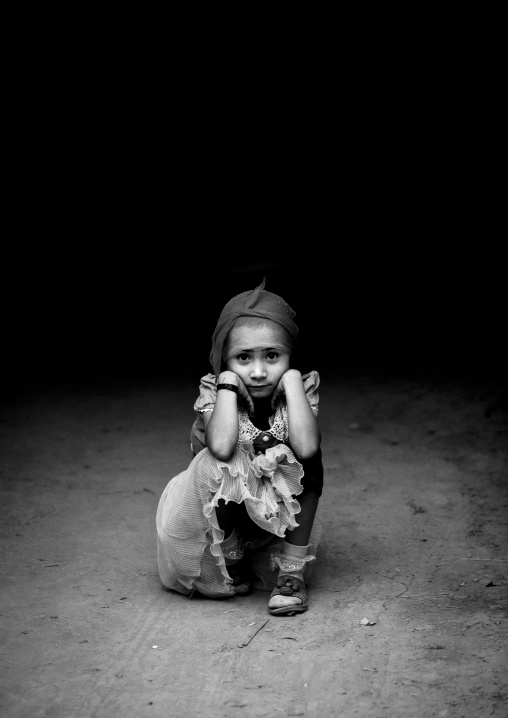 Young Uyghur Girl Squatting Alone In The Street, Yarkand, Xinjiang Uyghur Autonomous Region, China