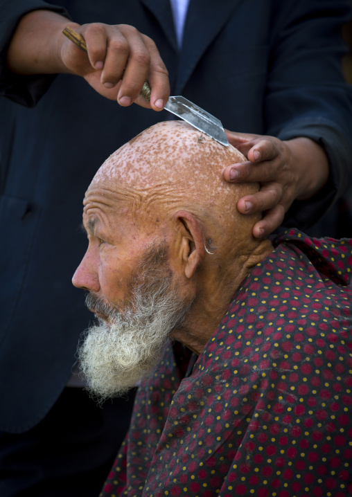 Uyghur Man Getting Shaved By A Barber At Serik Buya Market, Yarkand, Xinjiang Uyghur Autonomous Region, China