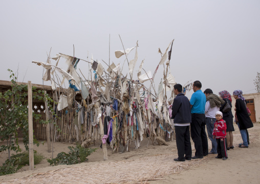 Family Praying At Imam Asim Tomb In The Taklamakan Desert, Xinjiang Uyghur Autonomous Region, China