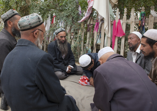 Uyghur Sufi Men Praying At Imam Asim Tomb In The Taklamakan Desert, Xinjiang Uyghur Autonomous Region, China