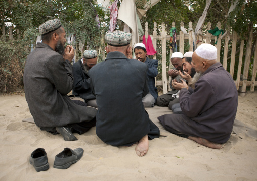 Uyghur Sufi Men Praying At Imam Asim Tomb In The Taklamakan Desert, Xinjiang Uyghur Autonomous Region, China