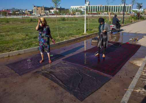 Uyghur Women Cleaning Carpets In Old Town Of Kashgar, Xinjiang Uyghur Autonomous Region, China