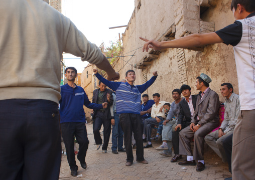 Men dancing in the street during a Wedding In Uyghur Family, Kashgar, Xinjiang Uyghur Autonomous Region, China