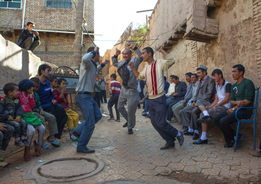 Men dancing in the street during a Wedding In Uyghur Family, Kashgar, Xinjiang Uyghur Autonomous Region, China