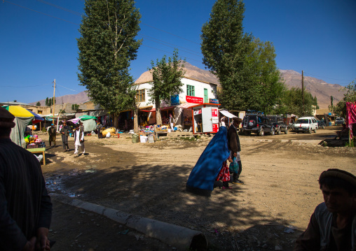 Woman in burka passing in the market street, Badakhshan province, Ishkashim, Afghanistan