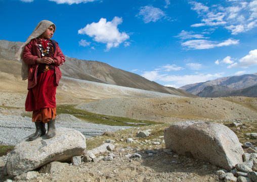 Wakhi nomad girl standing on a rock, Big pamir, Wakhan, Afghanistan