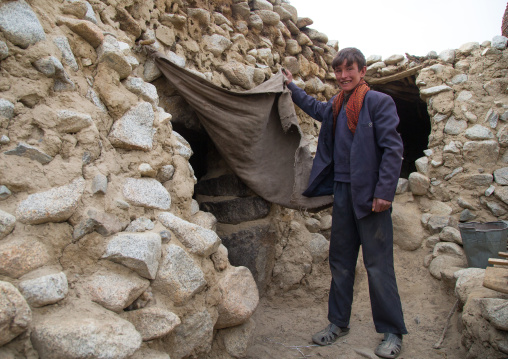 Wakhi teenage boy at the entrance of his house, Big pamir, Wakhan, Afghanistan