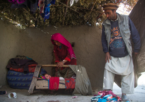 Mother looking after her baby sleeping in a craddle, Badakhshan province, Qazi deh, Afghanistan