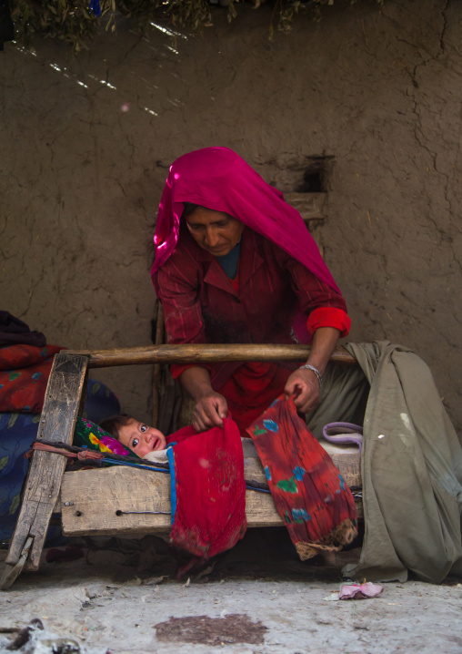 Mother looking after her baby in a craddle, Badakhshan province, Qazi deh, Afghanistan