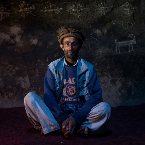 Afghan man sit inside his traditional pamiri house decorated for nowruz, Badakhshan province, Qazi deh, Afghanistan