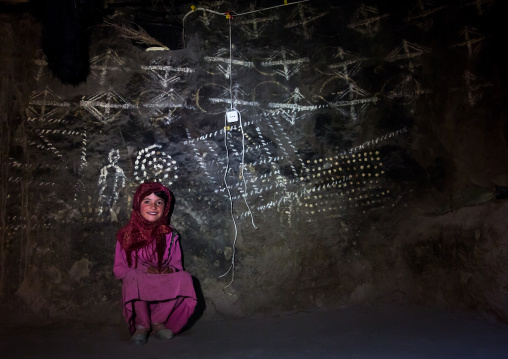 Afghan girl inside a traditional pamiri house decorated for nowruz, Badakhshan province, Qazi deh, Afghanistan