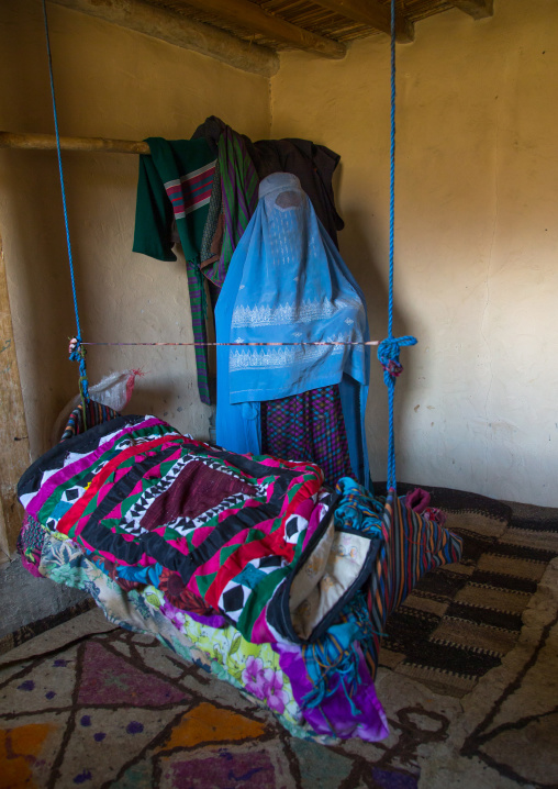 Woman with a burka in front of a craddle, Badakhshan province, Zebak, Afghanistan