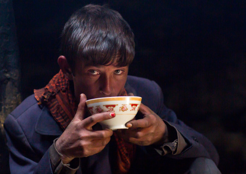 Wakhi teenage boy drinking salty milk tea, Big pamir, Wakhan, Afghanistan