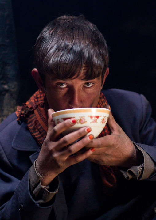 Wakhi teenage boy drinking salty milk tea, Big pamir, Wakhan, Afghanistan