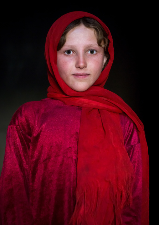 Portrait of an afghan girl with pale skin wearing red clothes, Badakhshan province, Khandood, Afghanistan