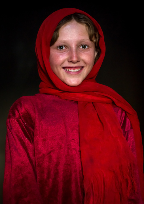 Portrait of an afghan girl with pale skin wearing red clothes, Badakhshan province, Khandood, Afghanistan