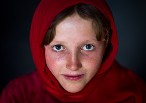 Portrait of an afghan girl with pale skin wearing red clothes, Badakhshan province, Khandood, Afghanistan