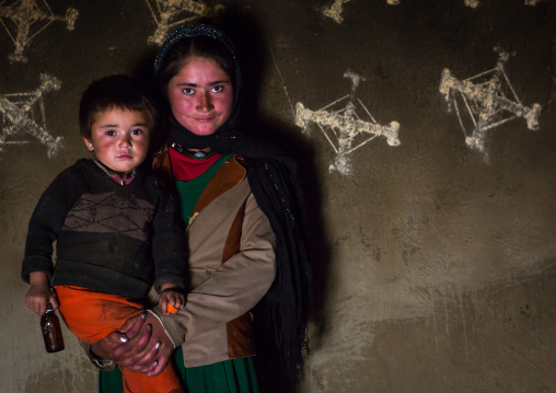 Afghan children in front of nowruz decorations on the walls, Badakhshan province, Zebak, Afghanistan