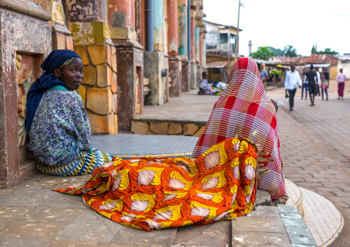 Benin, West Africa, Porto-Novo, teenagers sit in front of the multicoloured great mosque