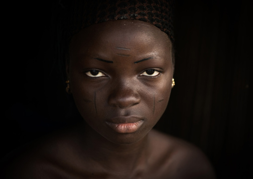 Benin, West Africa, Onigbolo Isaba, holi tribe woman covered with traditional facial tattoos and scars portrait