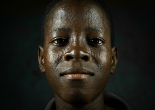 Benin, West Africa, Koussou, a somba tribe teenager with his face covered with linear scars