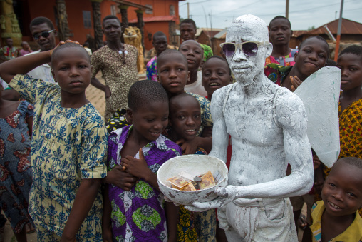 Benin, West Africa, Savalou, man disguised as an angel collecting money in the street