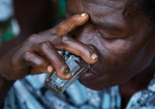 Benin, West Africa, Bopa, woman drinking alcohol during a voodoo ceremony