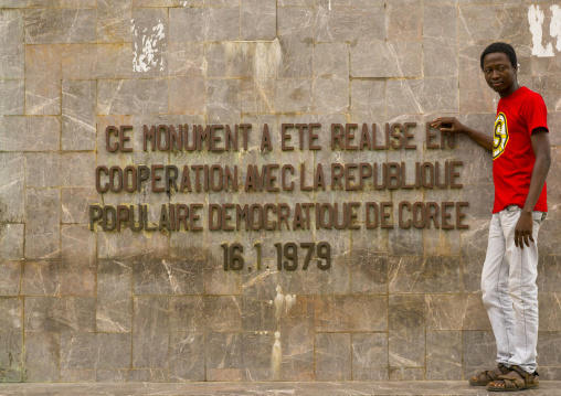 Benin, West Africa, Cotonou, beninese man pausing in front of 1977 martyrs monument made by north korean artists