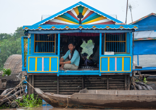 Cambodian woman standing at the door of her house in the floating village on Tonle Sap lake, Siem Reap Province, Chong Kneas, Cambodia