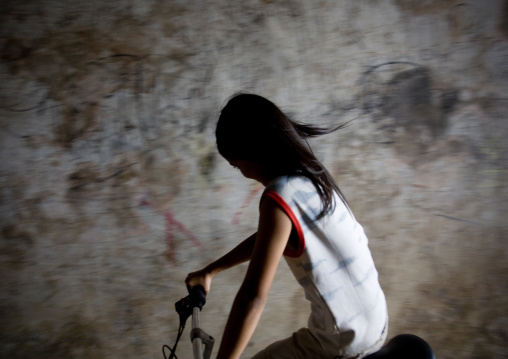 Portrait of a cambodian girl riding a bicycle, Phnom Penh province, Phnom Penh, Cambodia