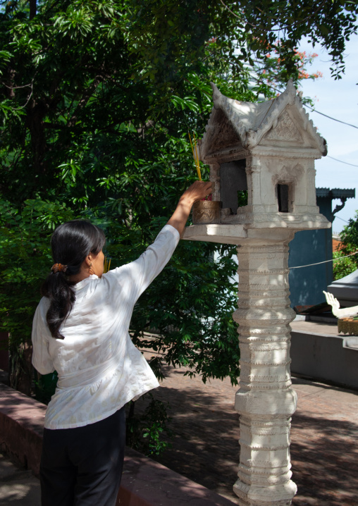 Cambodian woman burning incense sticks, Phnom Penh province, Phnom Penh, Cambodia