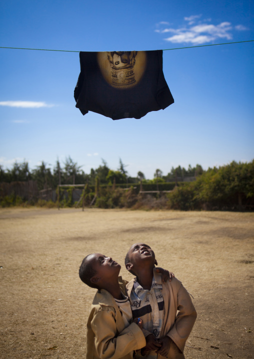 Kids Looking At A T-shirt With The Portrait Of Haile Selassie, Shashemene Jamaican School, Oromia Region, Ethiopia