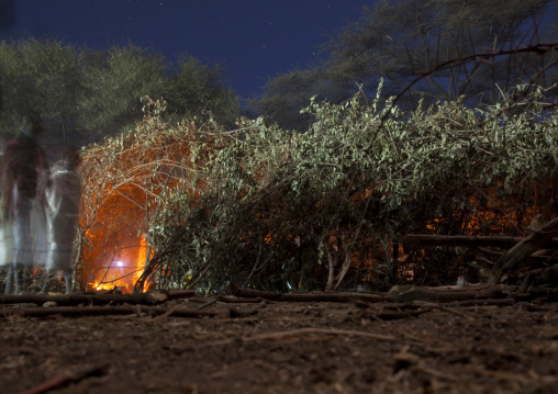 Night View Of Karrayyu Tribe People Standing Near Karrayyu Tribe House During Gadaaa Ceremony, Metahara, Ethiopia