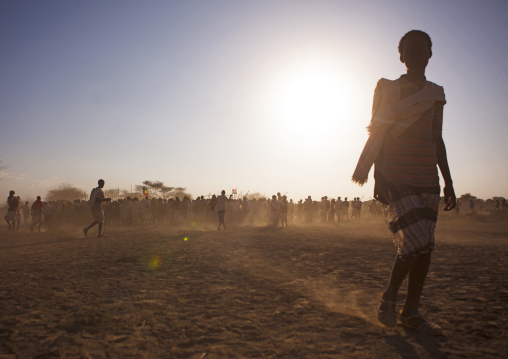 Karrayyu Tribe Kid And Group Of Karrayyu People At Sunset During Gadaaa Ceremony, Metahara, Ethiopia