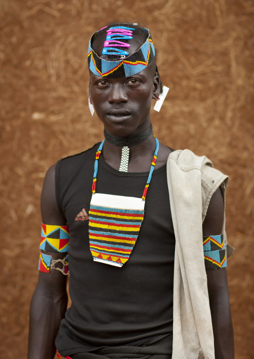 Fashionable tsemay tribe man posing in key afer, Omo valley, Ethiopia