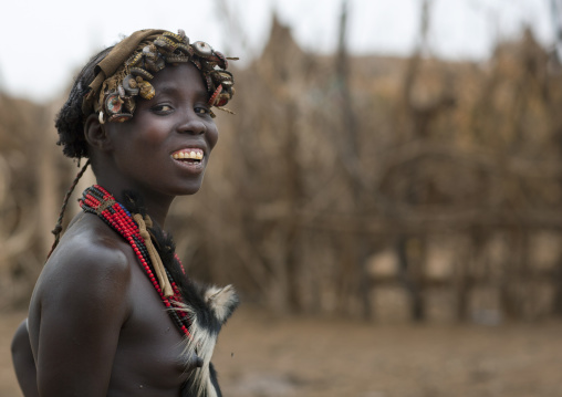 Young Smiling Dassanech Woman Wearing Bottle Caps Headdress Portrait Omo Valley  Ethiopia