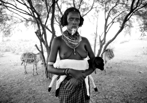 Beautiful Naked Breasts Dassanech Woman With Beaded Necklaces And Black And White Baby Goats In Arms Omorate Ethiopia