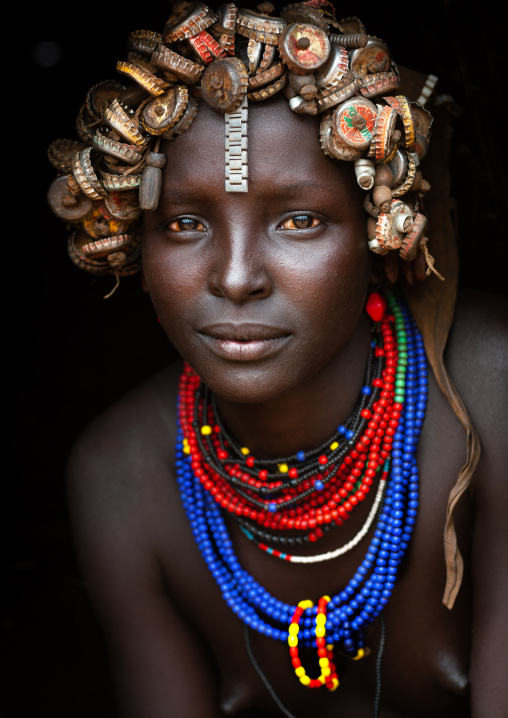 Portrait Of A Young Dassanech Cute Woman Wearing Bottle Caps Headgear And Beaded Necklaces Omo Valley Ethiopia