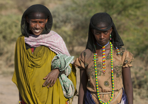 Portrait Of Smiling Oromo Tribe Women With Black Headscarf And Colourful Necklaces On The Road, Harar, Ethiopia