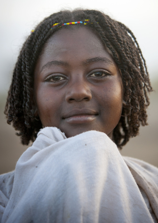 Portrait Of A Smiling Karrayyu Tribe Girl With Stranded Hair At Gadaaa Ceremony, Metehara, Ethiopia